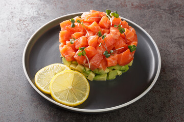 Salmon tartare with lemon, avocado, microgreen. Beautiful snack, dietary food, appetizer