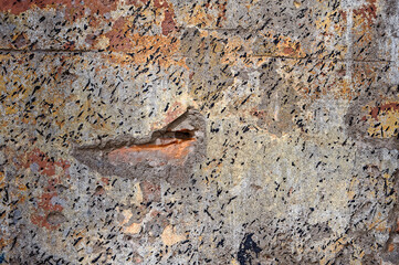 Old wall with peeling plaster and paint.