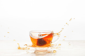 Cup of tea with a bag. Tea drink splash