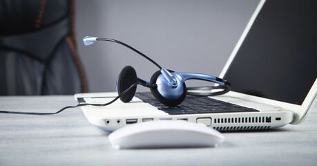 Customer service headset and laptop computer.
