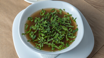 Close-up view of mushroom soup with green onions and champignons. Healthy food concepts.