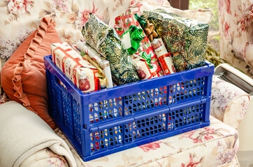 Wrapped Christmas presents in a plastic crate