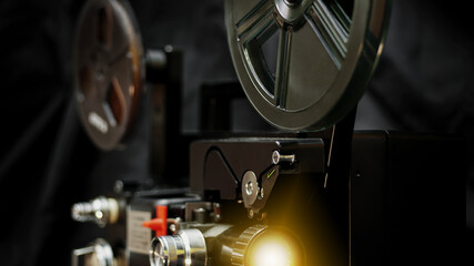 Fototapeta premium 8 mm movie projector on dark background with beam. 