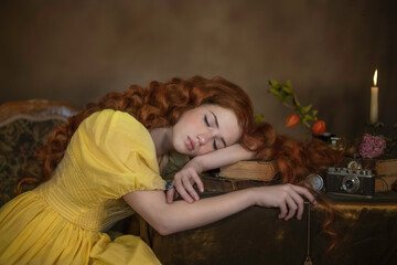 Portrait of a red-haired girl lying on the table