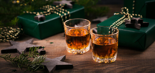 Two shot glasses of whiskey or bourbon with Holiday decoration