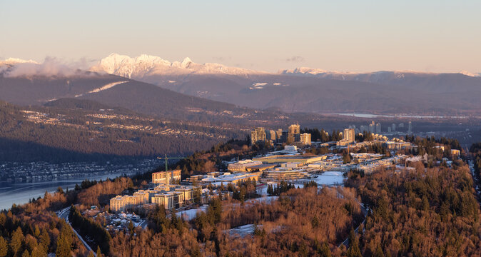 Aerial view of Simon Fraser University, SFU, on Burnaby Mountain. Picture taken from an Airplane in Vancouver Lower Mainland, British Columbia, Canada. Sunny Winter Sunset