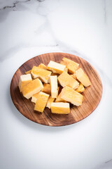 Tamago served on wooden plate on white table background. Japanese oven baked omelette Tamagoyaki or egg roll. Sushi bar or restaurant menu. Traditional sweet and savory food. Copy space