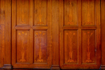 Traditional wood carving on brown wood..