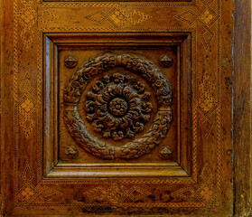 Traditional wood carving on brown wood..