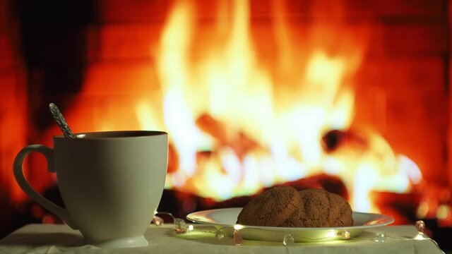 Cup of tea and cookies by the fireplace