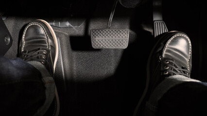 Accelerator and breaking pedal in a car. Close up the foot pressing foot pedal of a car to drive...