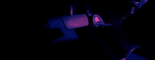 Accelerator and breaking pedal in a car. Close up the foot pressing foot pedal of a car to drive...