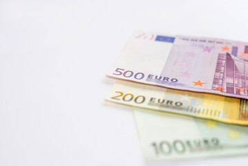 banknotes of 100, 200, 500 euros on a white background with copy space.