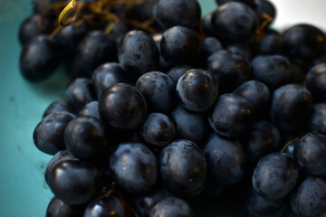Freshly washed red grapes in a colander