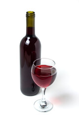 A glass of red wine and a bottle of wine on a white background. Alcoholic drink.