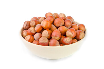 Obraz premium Hazelnuts in an old ceramic dish