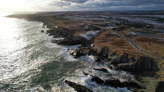 Waves crashing along the coastline in winter