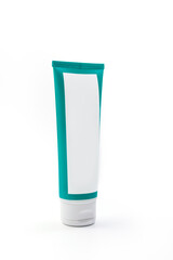Cosmetic cream green tube. Sskincare cosmetic package. Plastic toothpaste tube. Product in green tubeisolated on white background. Clipping path included.