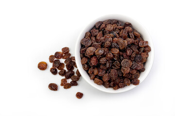 Brown raisins in white bowl isolated on white background