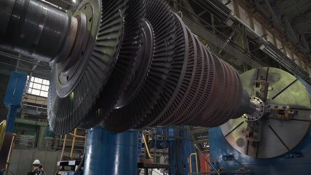 Turbine Manufacturing Facility. The Part of the Turbine is Spinning while it is Attached to the testing stand. Steam Turbine Assembly Process. Heavy Machinery. Industrial Plant. Production Process.