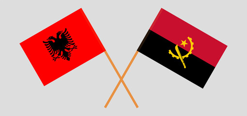 Crossed flags of Albania and Angola. Official colors. Correct proportion