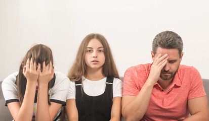 sad child between mother and father. family therapy. parents with kid having problems.