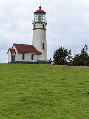 Fototapeta na wymiar Lush green grass surrounds the lighthouse at Cape Blanco State Park, Oregon, USA