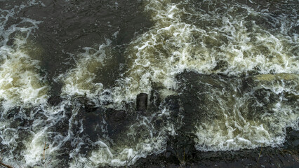 Boiling water in a cold river. Abstract background. Space for text.