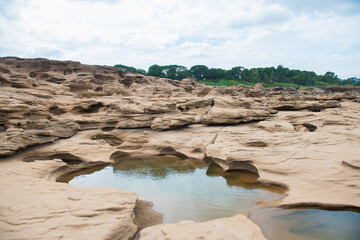 Colorful rocks, puddles and strange shaped rocks in the Mekong River