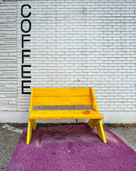 Yellow bench with spilled coffee and typography