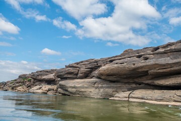 view from the boat: Rocks on both sides of the Mekong River