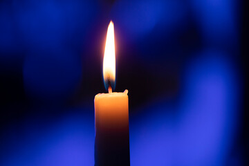 burning candle on black background. Candle. Light. Background. Bokeh. Photo