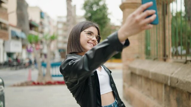 Young hispanic woman smiling confident make selfie by the smartphone at street