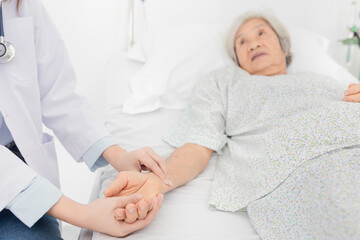 female doctor use hand screening vital sign of old asian patient , healthcare worker treatment...