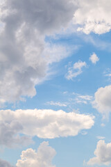 Blue sky with fluffy clouds on a sunny day