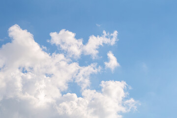Blue sky with fluffy clouds on a sunny day