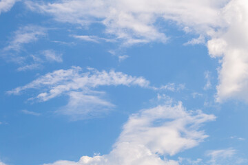 Blue sky with fluffy clouds on a sunny day