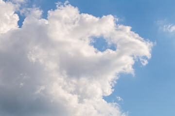 Blue sky with fluffy clouds on a sunny day