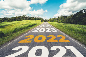 2022 New Year road trip travel and future vision concept . Nature landscape with highway road leading forward to happy new year celebration in the beginning of 2022 for fresh and successful start .
