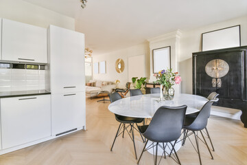 Mind-blowing dining room with oval table and black chairs and wood parquet floor