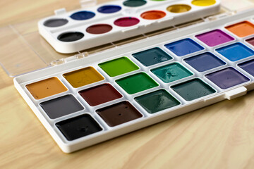 sets of watercolor paints on the table