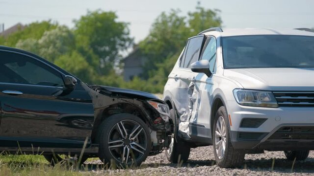 Damaged in heavy car accident vehicles after collision on city street crash site. Road safety and insurance concept