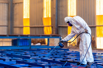 Airless Spray Painting, Worker painting on steel structure fabricated surface by airless spray gun for protection rust and corrosion. - obrazy, fototapety, plakaty