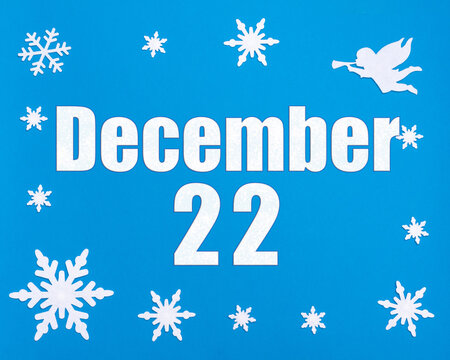 December 22nd. Winter blue background with snowflakes, angel and a calendar date. Day 22 of month.