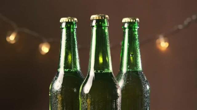 Drops Rolling Down on Bottles with Cold Refreshing Beer, Camera Zooming