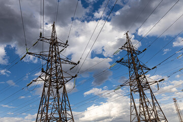 Rusty power line is on the blue sky with white clouds background