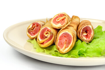 Salmon lavash rolls with cheese and herbs on glass plate, close up view