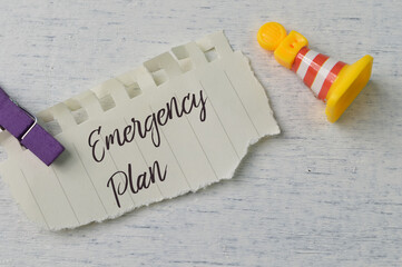 Torn paper written with text EMERGENCY PLAN