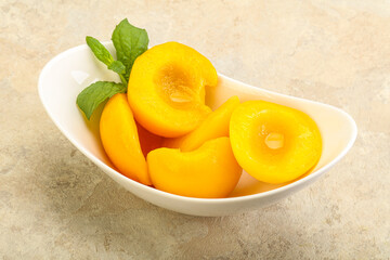 Sweet ripe canned peaches with mint