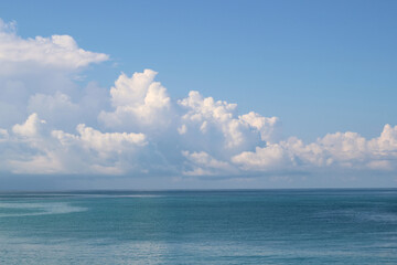 Naklejka na ściany i meble white clouds on a blue sky with the sea